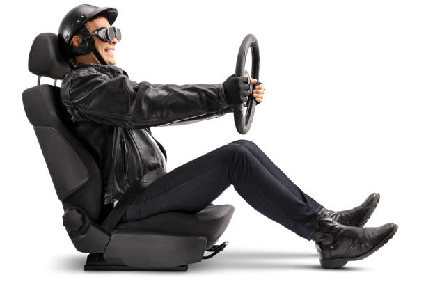 istock Biker sitting in a car seat and holding a steering wheel 869756898