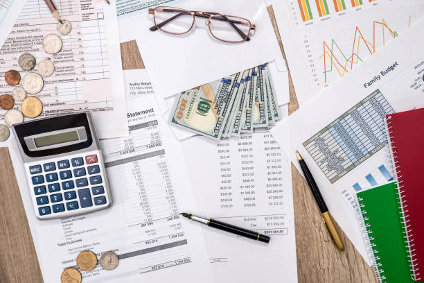 istock Financial statistics documents  - tax form, personal budget with money, pen, calculator 869757434