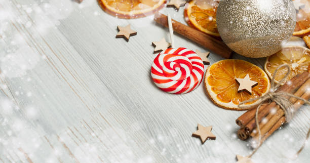 Christmas frame made from oranges. cinnamon, candies, various festive decor. copy space, free space for your text. close up