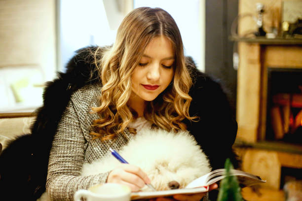 istock Young woman on break in cafe studying and drinking coffee 869758888