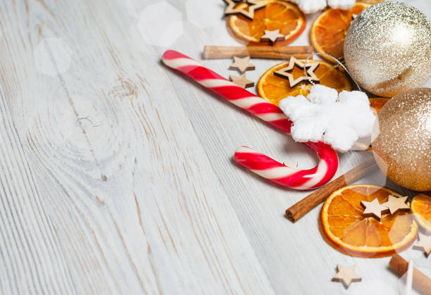 istock Christmas frame made from oranges. cinnamon, candies, various festive decor. copy space, free space for your text. close up 869758982