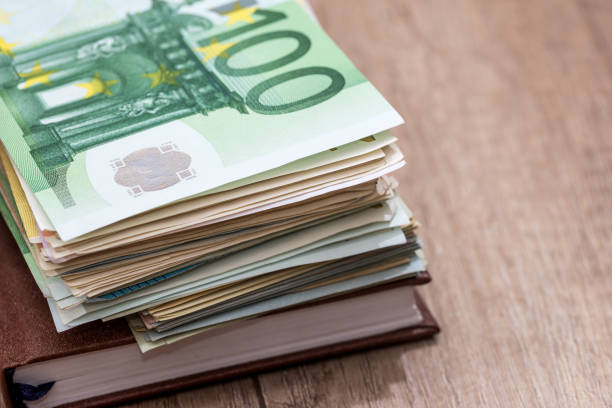 istock euro, notepad and on desk. close up 869759352