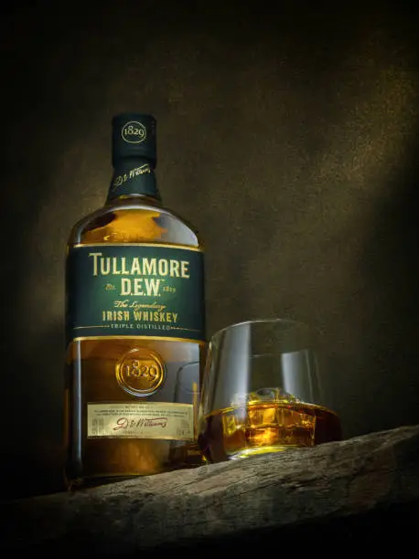 Bangkok,Thailand- February 18. 2017: Photo of bottle of "Tullamore Dew" Whiskey on Color background.Tullamore Dew is a brand of blended Irish whiskey produced by William Grant & Sons