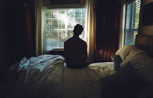 istock tired man waking up in the morning 869762760