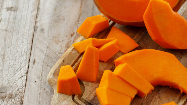 istock Pumpkin slices on a wooden background 869765378