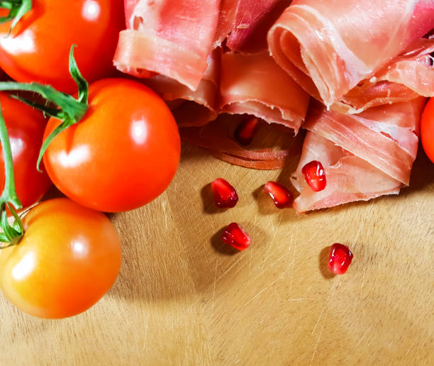istock jamon wooden board cherry tomato, oil, pomegranate, grain 869771762