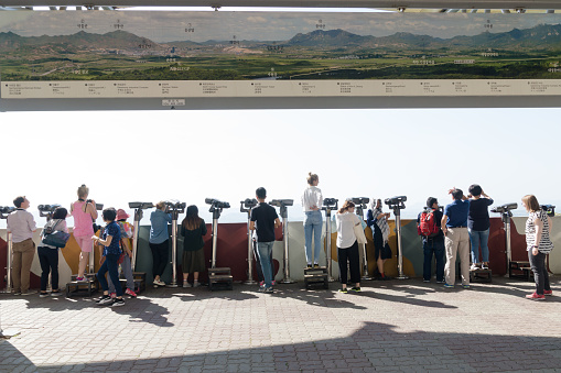 Dora Observatory, Dmz: Tourists watching with binoculars to North Korean village Propaganda village or Peace village at Korean Demilitarized Zone