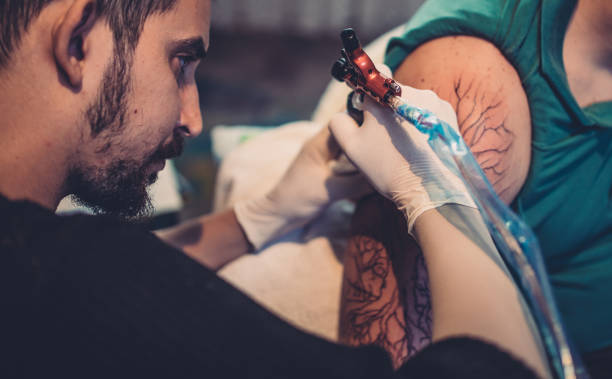 istock Bearded tattoo artist tattooing 869774694