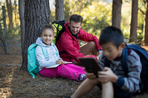 istock Teacher assisting girl in study 869779724