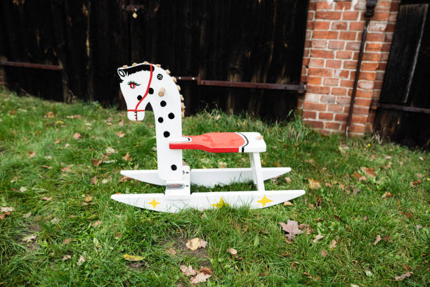 Old rocking horse before the barn door