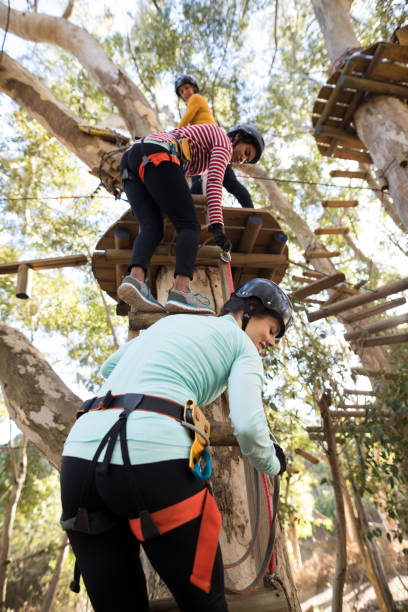istock Friends climbing on tree with stairs 869786060