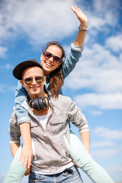 istock smiling teenagers in sunglasses having fun outside 869786700