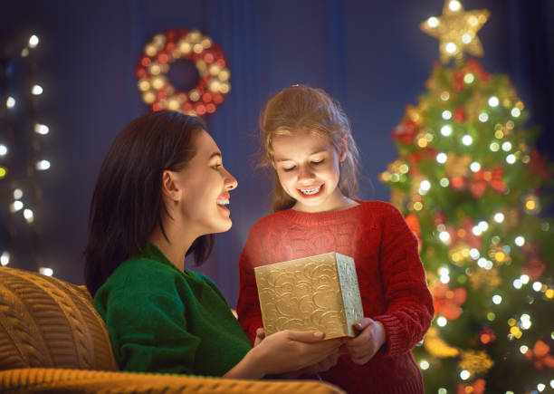 istock Mother and daughter exchanging gifts 869791348
