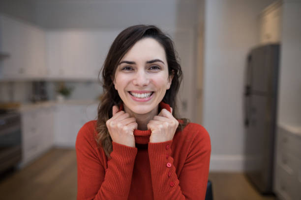 istock Happy woman sitting in kitchen 869793762