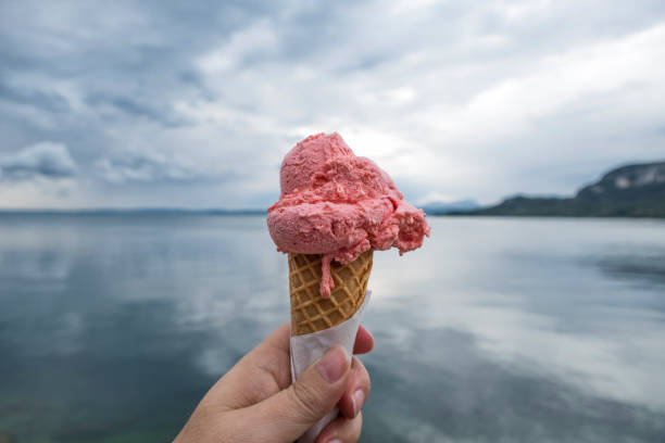 istock Pink Ice Cream in woman hand 869795530