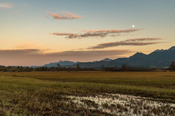 The rising moond with a puddle in the foreground