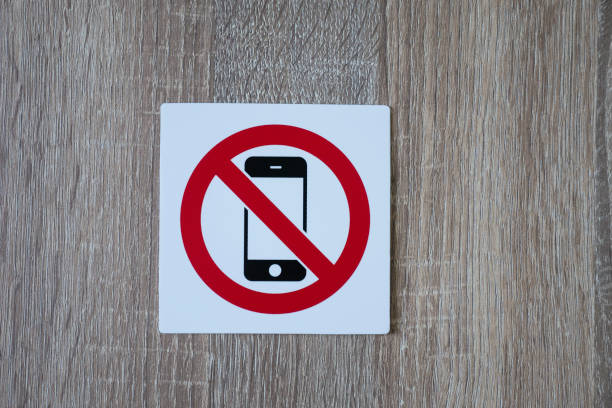 no phone allowed sign on wooden wall