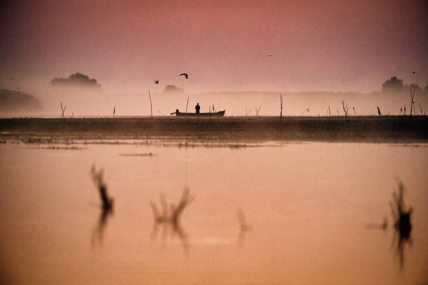 istock Fisherman in Danube Delta in the morning catching fish 869796418