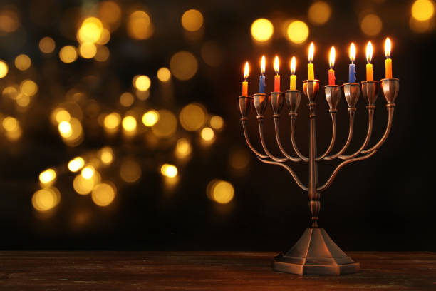 jewish holiday hanukkah background with menorah (traditional candelabra) and burning candles - candle hanukkah menorah candlelight imagens e fotografias de stock