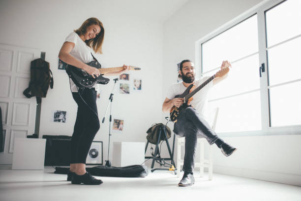 istock Couple playing guitar together 869800866