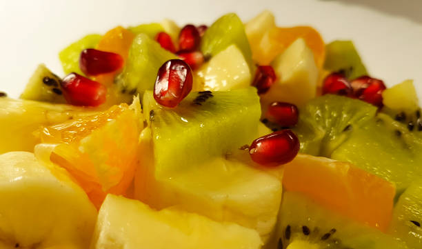 istock fruit salad banana, kiwi, orange, pomegranate background, antioxidant 869802172