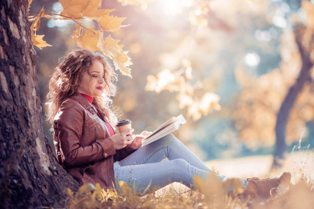 istock Woman in autumn park 869804362