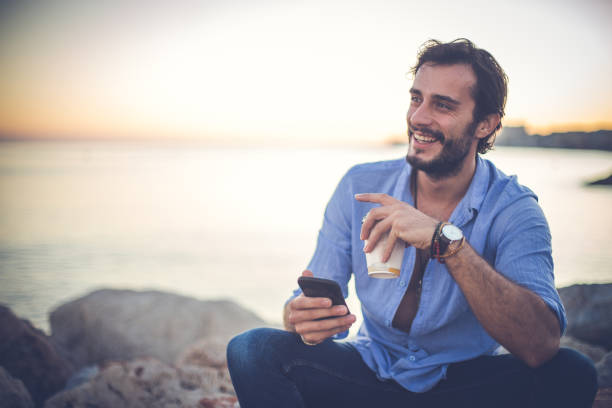 istock Handsome man relaxing at the beach 869805916