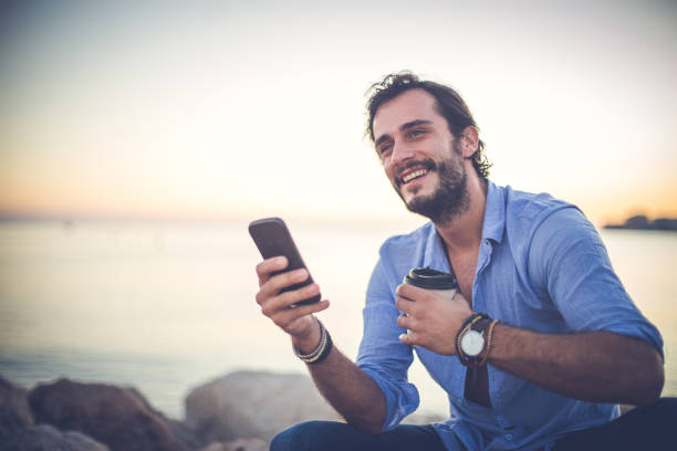 istock Young man relaxing at the beach 869806036