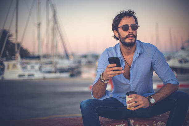 istock Young man relaxing in harbor 869806168