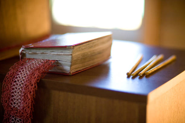 istock Prayer book and candles 869808782