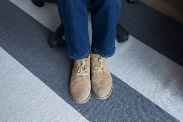 istock Low section of man wearing shoes 869810350