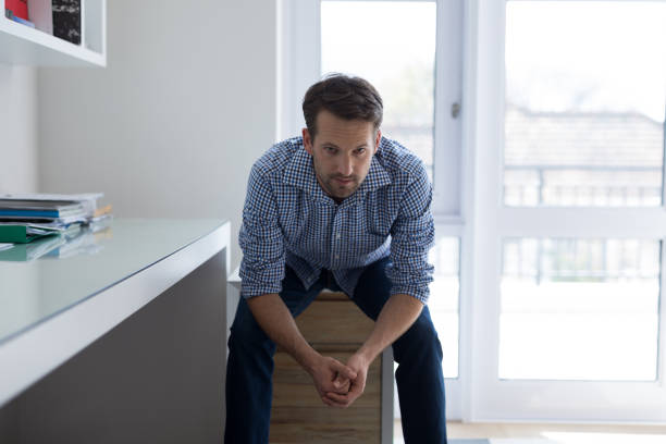 istock Portrait of confident man sitting on drawer 869813986