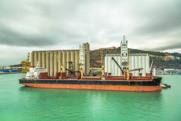 Docked cargo ship with silos stock photo