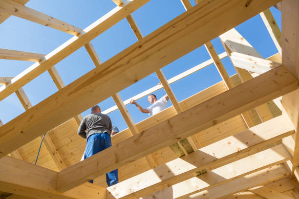 builders at work with wooden roof construction. - carpenter construction residential structure construction worker imagens e fotografias de stock