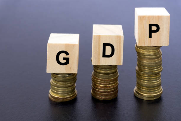 istock GDP Word on Wood Block On Top Of Coins Stack 869819212