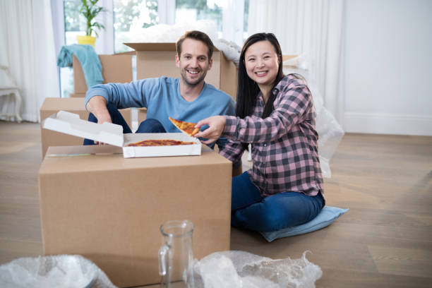 istock Couple having pizza at their new home 869819214