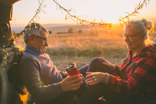 istock Senior couple outdoors with car 869828980