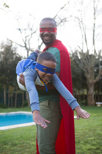 istock Son and father pretending to be a superhero 869830038