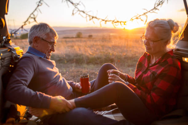 istock Senior couple outdoors with car 869831024