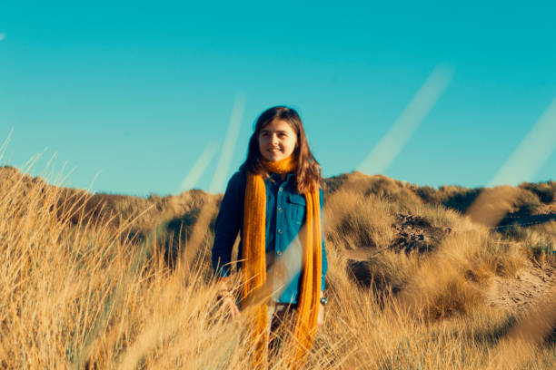 istock Child smiling amongst the sand dunes 869831606