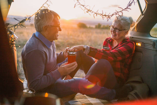 istock Senior couple outdoors with car 869833908
