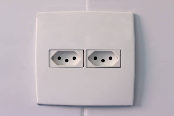 AC power double socket on wall, bad incorrectly installed, copy space. Socket for europlug type. Violations of safety standards. Fire-hazard.