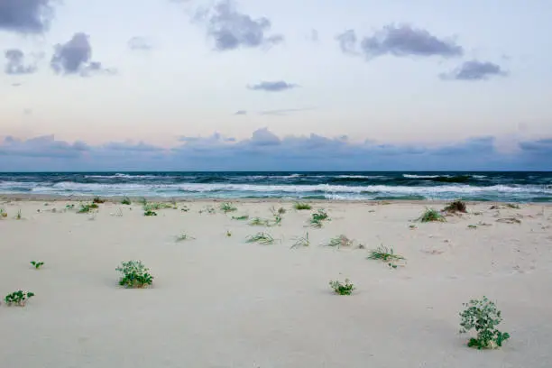 Sandy empty sea coastal seaview, cloudy colourful sunrise sky view