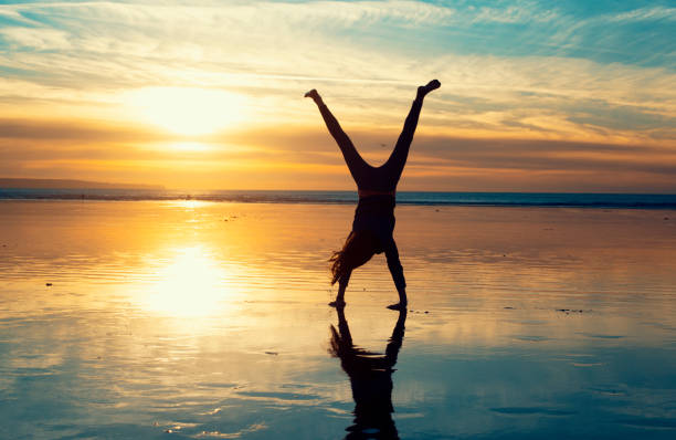 istock Cartwheels on the beach at sunset 869834430