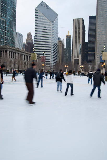 McCormick Tribune Ice Rink at Millenium Park The iconic ice skating rink in Millennium Park is a must stop each winter season. There's free ice skating daily, with one of the best views of Chicago's downtown skyline. On the background, there's Crain Communications Building, built by Sheldon Schlegman in the 80's. millennium park stock pictures, royalty-free photos & images