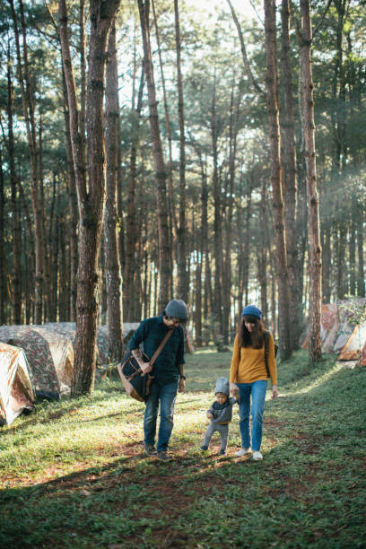 istock Asian parents and baby walking past in a forest 869838794