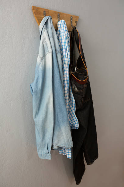 istock Jeans, denim jacket and shirt hanging on hook 869838838