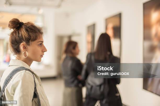 Group Of Woman Looking At Modern Painting In Art Gallery Stock Photo - Download Image Now