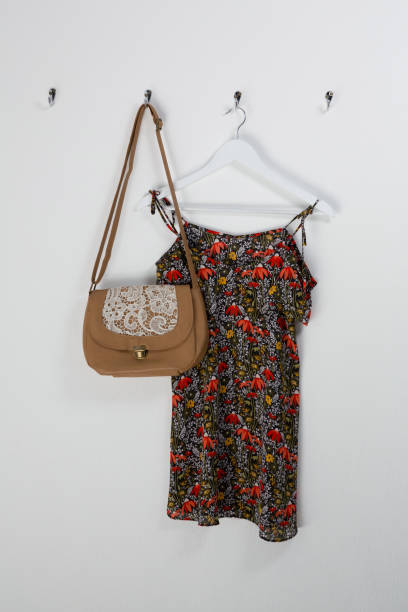 istock Dress and bag hanging on hook 869841350