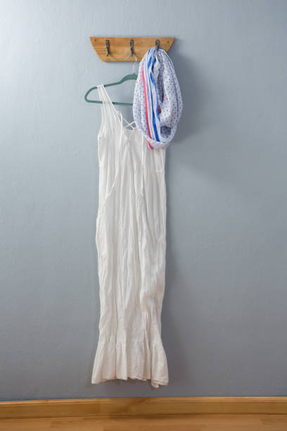 istock White dress and scarf hanging on hook 869841438